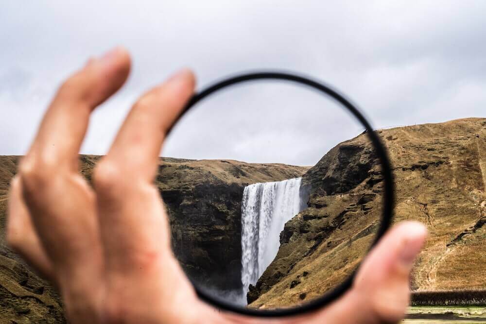 viewing waterfall clearly through a lens
